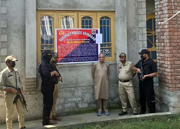 Police attaches property belonging to designated terrorist in Srinagar on Saturday. (UNI)