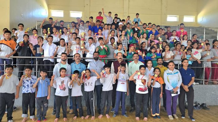 Athletes displaying medals alongside dignitaries during prize distribution ceremony. Athletes displaying medals alongside dignitaries during prize distribution ceremony.