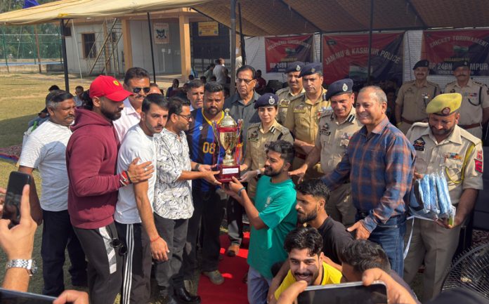 Dignitary presenting winner's trophy to winning team captain during prize distribution ceremony.