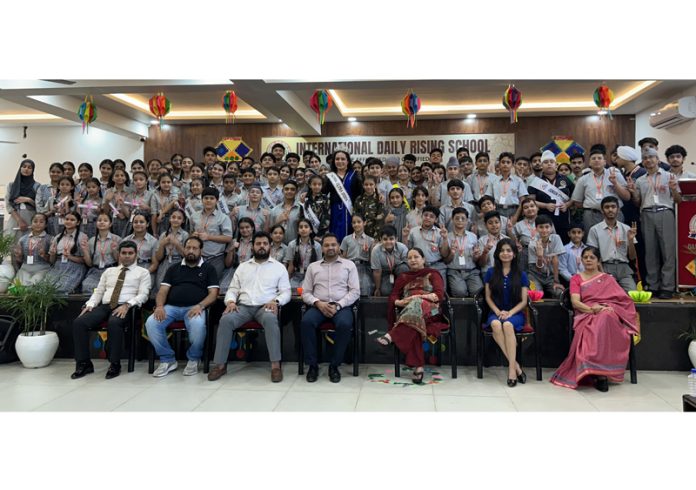 Students posing with guests and school management during a function at IDRS Jammu.