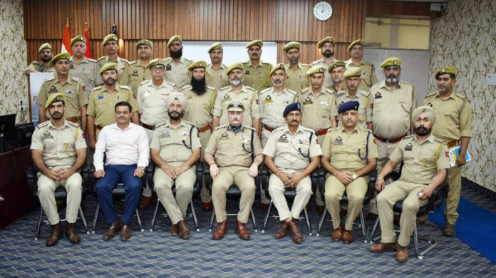 Police personnel participating in training courses at PTTI Vijaypur posing for a group photograph.