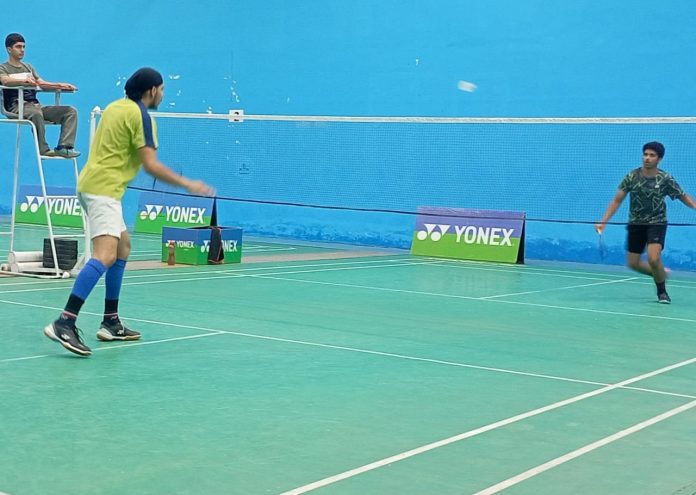 Badminton players in action during a match in MA Stadium Jammu on Sunday.