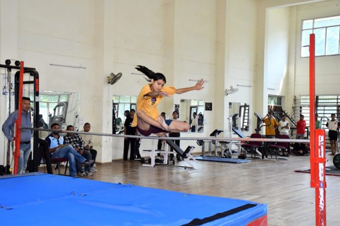 An athlete in action during High Jump event at Inter Zonal District Level Athletics Meet for AAG Girls at University of Jammu.
