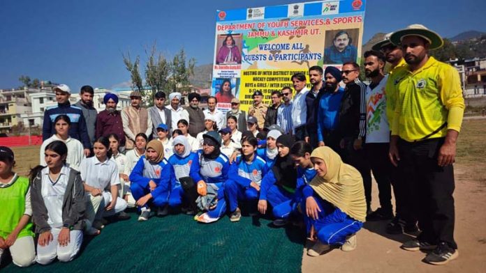 Girls cricket players posing along with dignitaries.