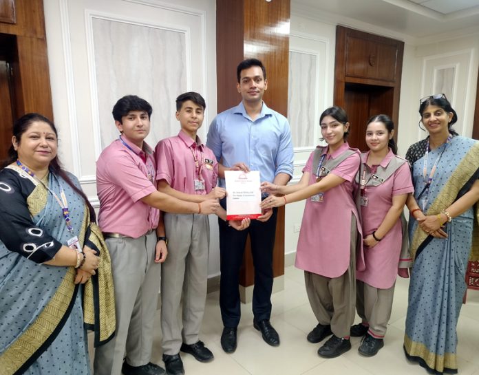 Jodhamal students present Rs 5 lakh flood relief cheque to DC Jammu.