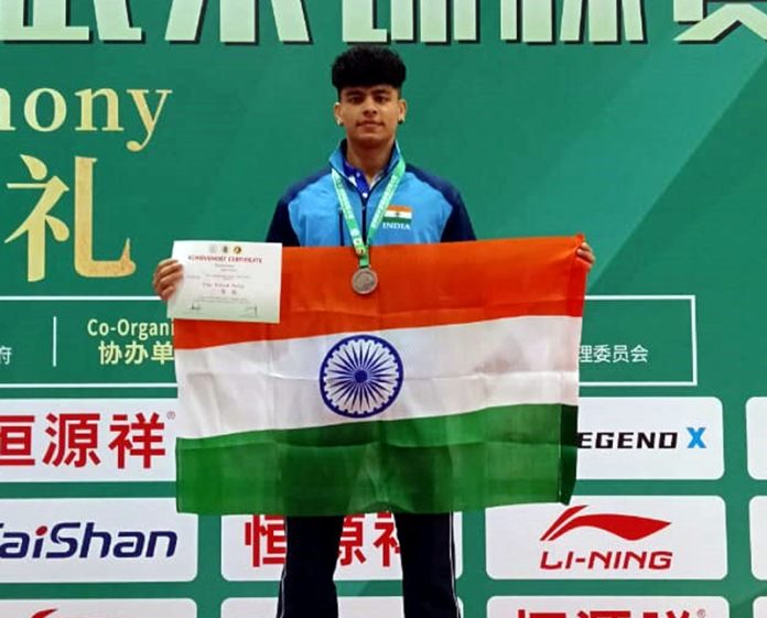 Ranjeet Singh with his bronze medal, certificate and national flag at World Kungfu Wushu Championship, China.