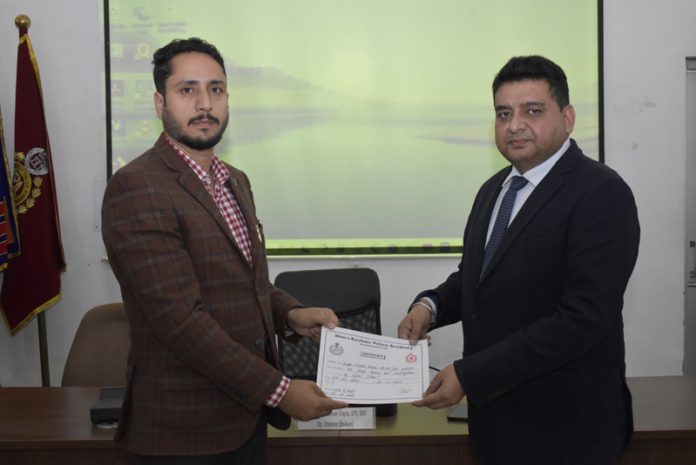 SSP Rajinder Gupta presenting a certificate to a police officer at SKPA Udhampur on Wednesday.
