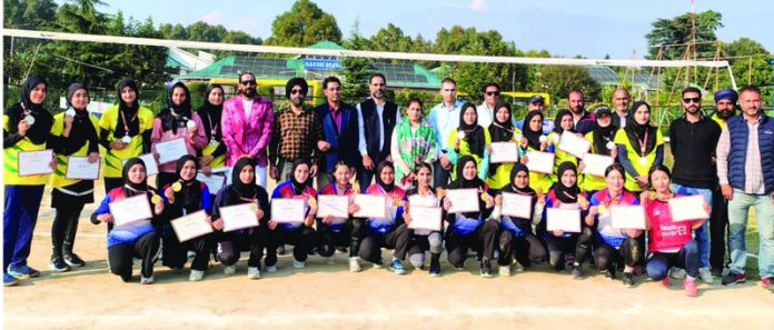 GCOPE Ganderbal team posing with guests after winning women’s volleyball event.