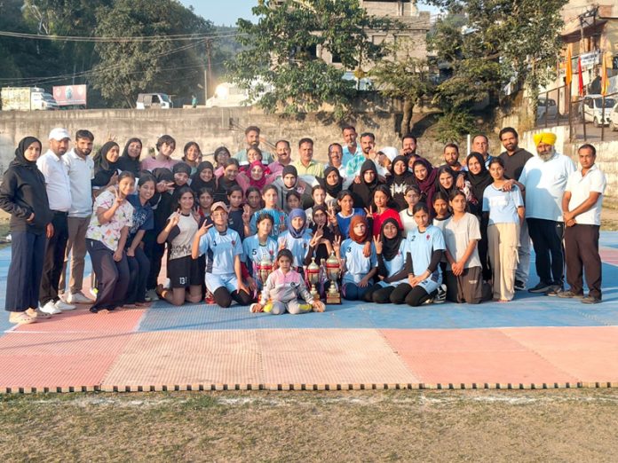 Winning teams posing along with trophy and dignitaries.