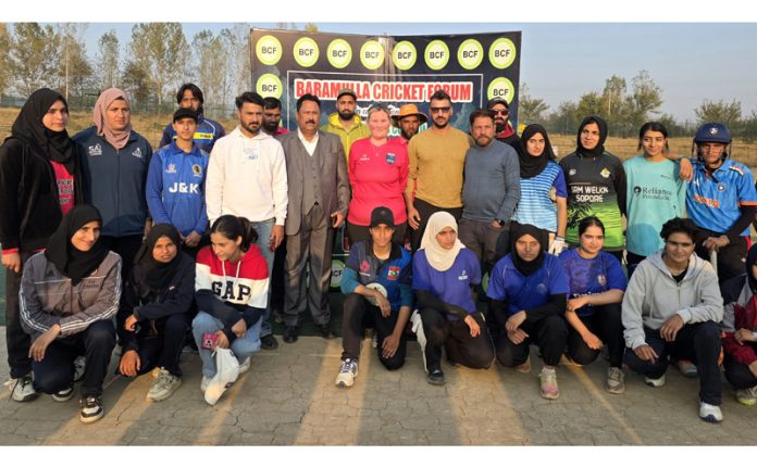 Mel Juniper posing along with women cricketers during inaugural event of Women's Premier League in Baramulla. — Excelsior/Abid Nabi