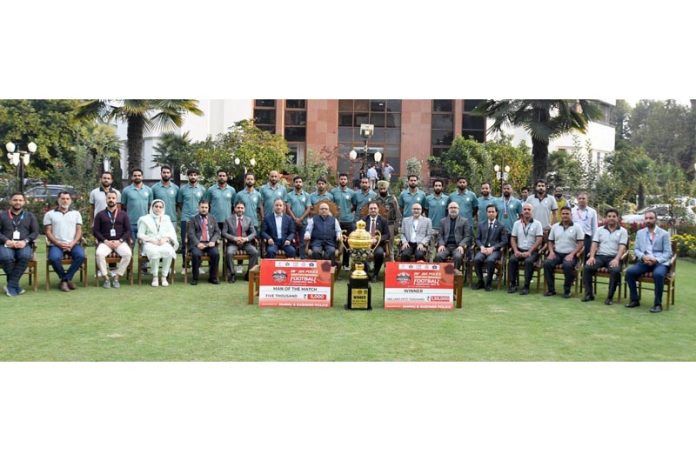 J&K Bank MD & CEO Amitava Chatterjee and officials pose with the football team during felicitation ceremony.