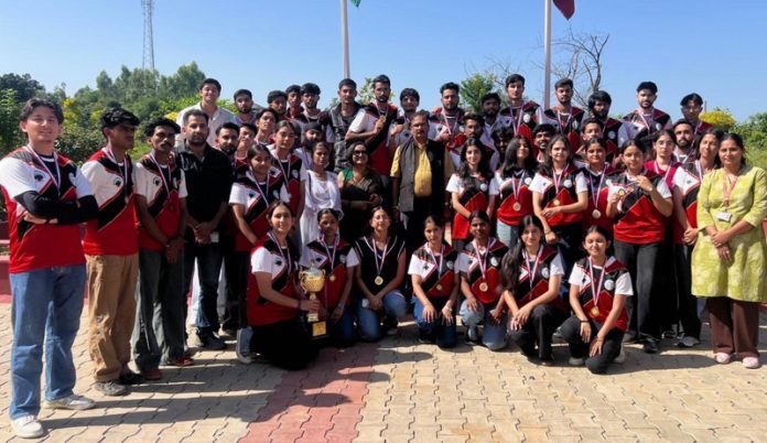 Central University of Jammu team posing along with medals and trophy.