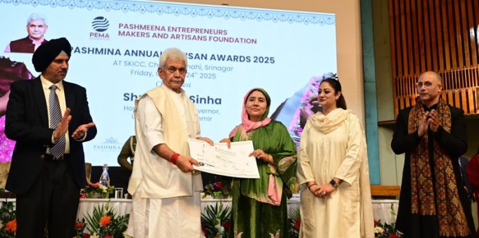 LG felicitating a craftperson during a ceremony at Srinagar on Friday.