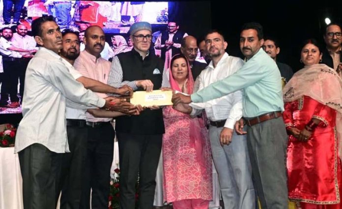 Chief Minister handing over regularization order to a CPW on Thursday.