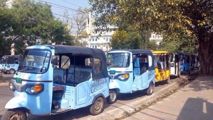 E-autos parked along a city road in Jammu.