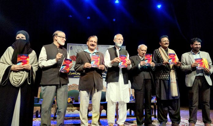 Poetry collection being released during an event at Tagore Hall in Srinagar on Sunday. -Excelsior/Shakeel