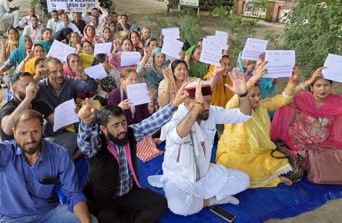 Daily wagers staging protest dharna near Press Club in Jammu on Friday. -Excelsior/Rakesh
