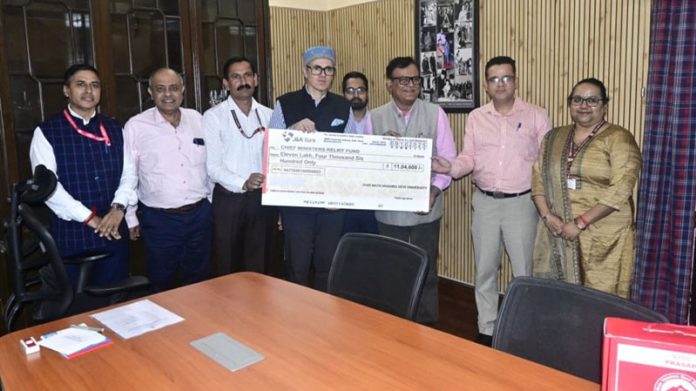 CM receiving a cheque from SMVDU faculty on Thursday.