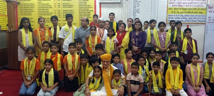 Pawan Kumar Shastri posing along with the students during an event in Jammu.