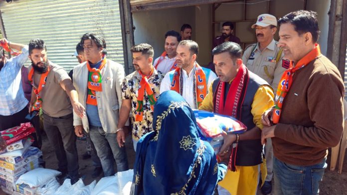 BJP leader Neelam Langeh distributing relief material among the flood affected families.