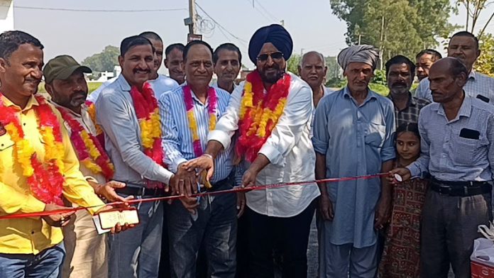 MLA R S Pura G R Bhagat and DDC member T S Tony kick-start blacktopping work of a road in Suchetgarh.
