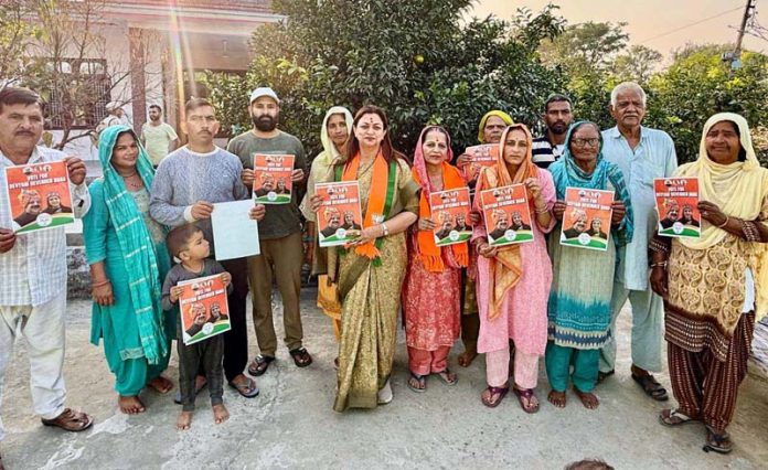BJP vice president, Rekha Mahajan during campaigning in Nagrota constituency on Wednesday.