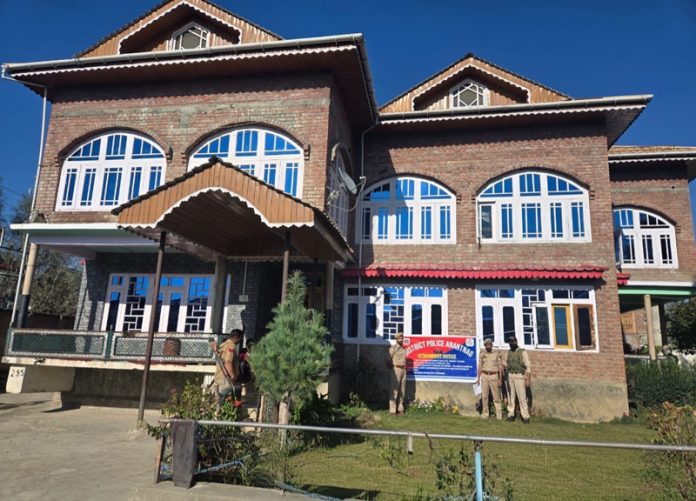 Police personnel pasting order of attachment on a property in Bijbehara area of Anantnag district. -Excelsior/Sajad Dar