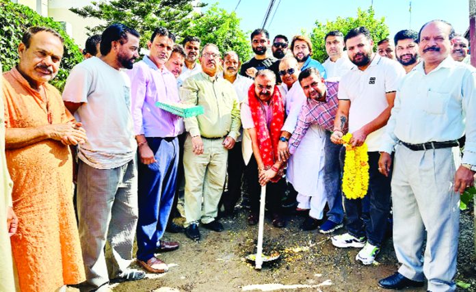 MLA Bahu, Choudhary Vikram Randhawa kick starting lane and drain work in Malik Market on Friday.