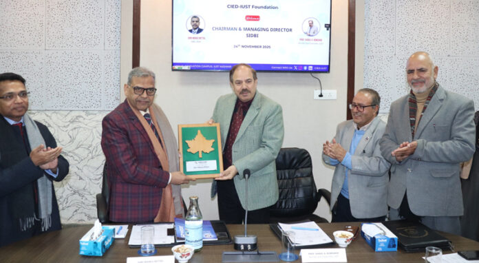 Prof Shakil A Romshoo, Vice Chancellor IUST, presenting a memento to Manoj Mittal during a function on Monday.