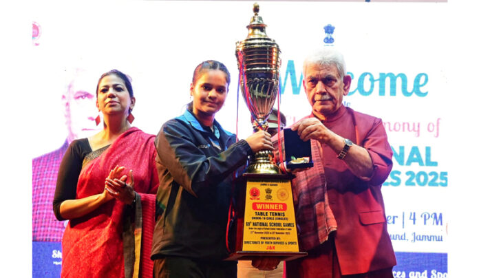 LG Manoj Sinha awarding a participant at National School Games in Jammu on Tuesday.