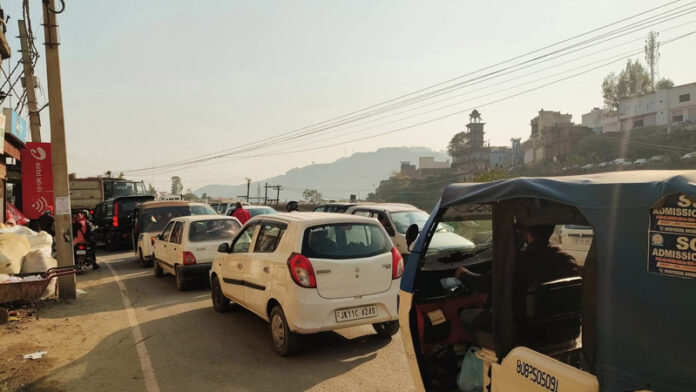Vehicles stranded due to traffic jam at Bela Road Rajouri.