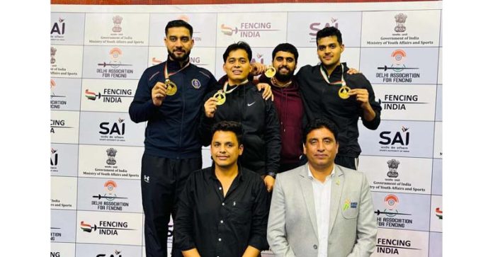 J&K Fencing team posing with Gold medals.