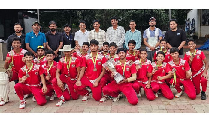 Winning team posing along with trophy.