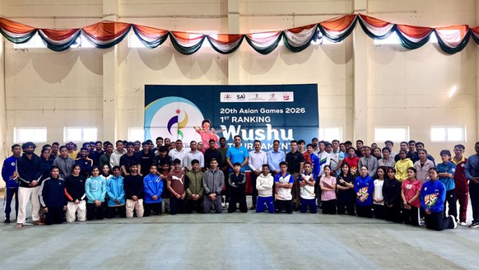Wushu Athletes posing along with dignitaries during closing ceremony.