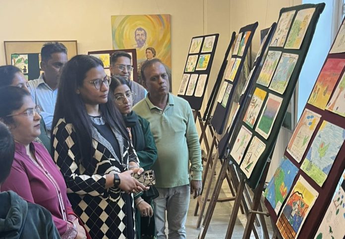 Guests witnessing the painting exhibition in Jammu on Wednesday.