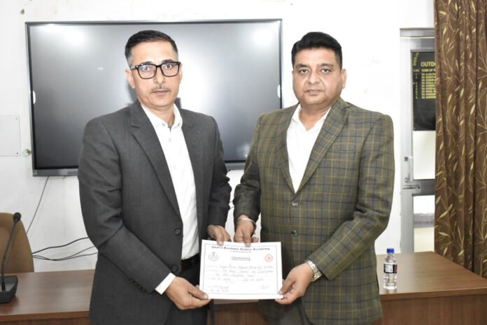 Rajinder Kumar Gupta, SSP presenting a certificate to a participant during a function at SKPA in Udhampur.