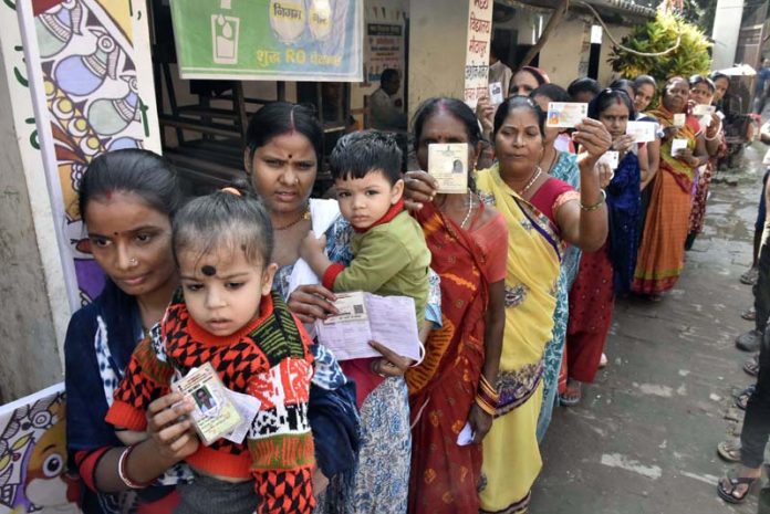 Voters waiting in queue for their turn to cast vote outside a Poling Station during the first phase of the Bihar Assembly elections, in Patna on Thursday. (UNI)