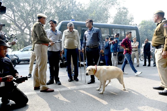 Security personnel and Dog Squad present at the Patiala house court after a bomb threat call, in New Delhi on Tuesday. (UNI )