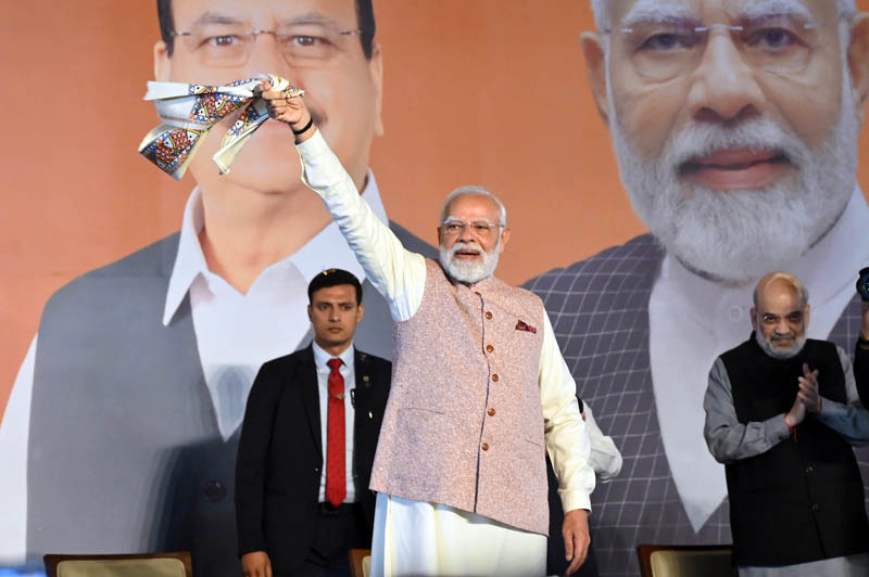 PM Narendra Modi greets party workers and leaders at BJP headquarters, in New Delhi on Friday. (UNI)