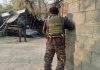 Security personnel stand guard during CIK raid in Kashmir on Tuesday. -Excelsior/ Sajad Dar