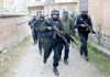 Police during raids at Larkipora, Anantnag on Wednesday.