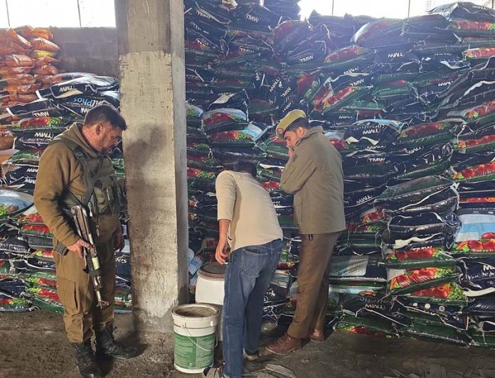 Cops inspecting a fertiliser shop at Nai Basti, Anantnag on Sunday. Cops inspecting a fertiliser shop at Nai Basti, Anantnag on Sunday.