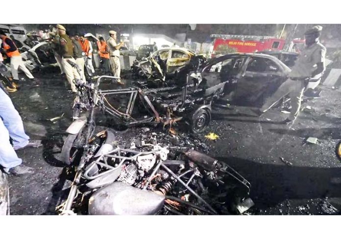 Mangled remains of vhicles gutted at the explosion site in Red Fort area, in New Delhi on Monday.