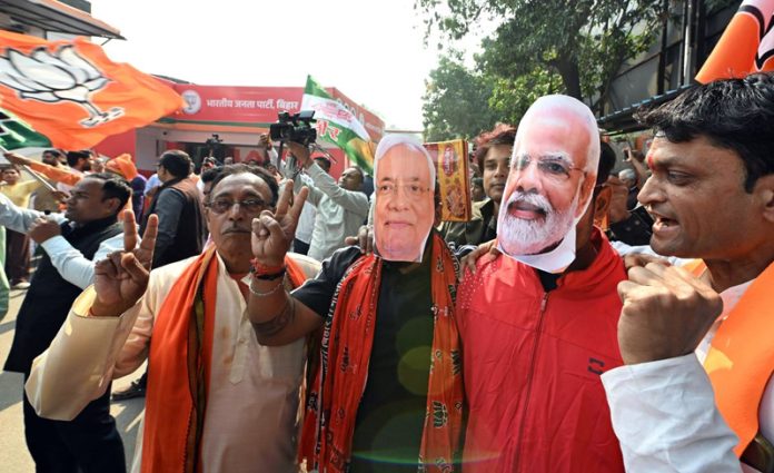 BJP supporters celebrate NDA’s victory in Bihar Assembly Election at party office, in Patna on Friday.