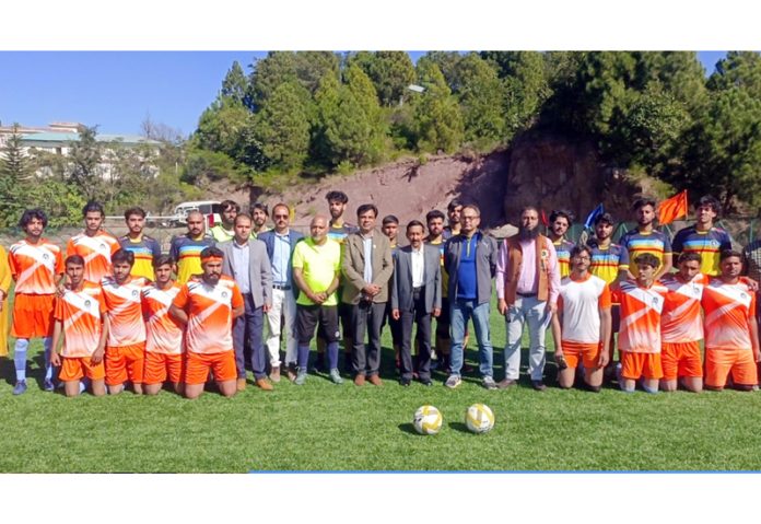 Football players along with University management posing for group photograph during an event. Football players along with University management posing for group photograph during an event.