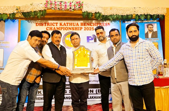 Dignitaries presenting trophy during an event.