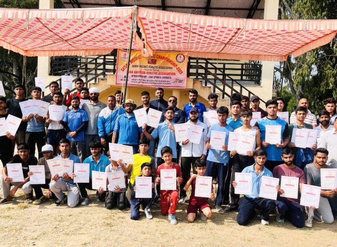 Athletes posing along with certificates during closing ceremony.