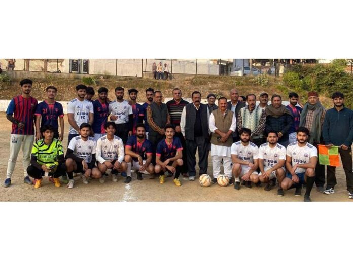 Dignitaries posing along with football players.