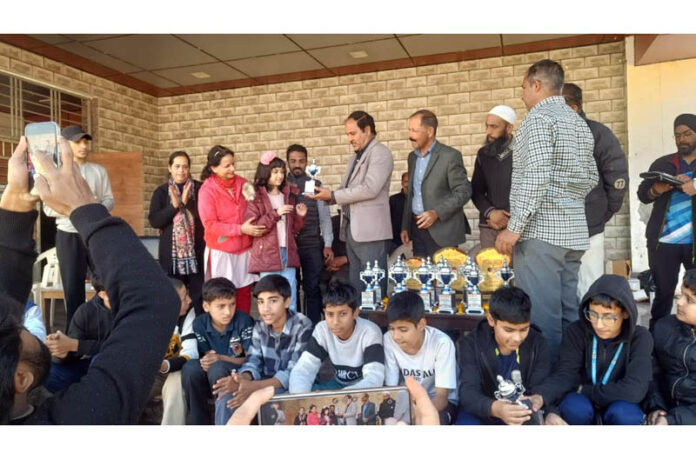 Dignitary presenting trophy to a player.