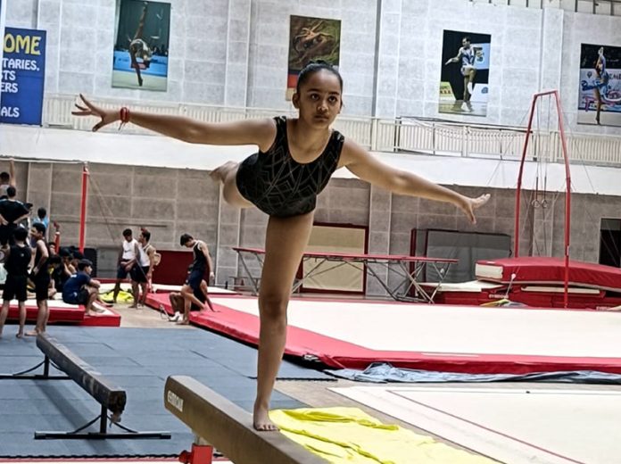 A gymnast displaying her skills during a competition in Jammu. A gymnast displaying her skills during a competition in Jammu.